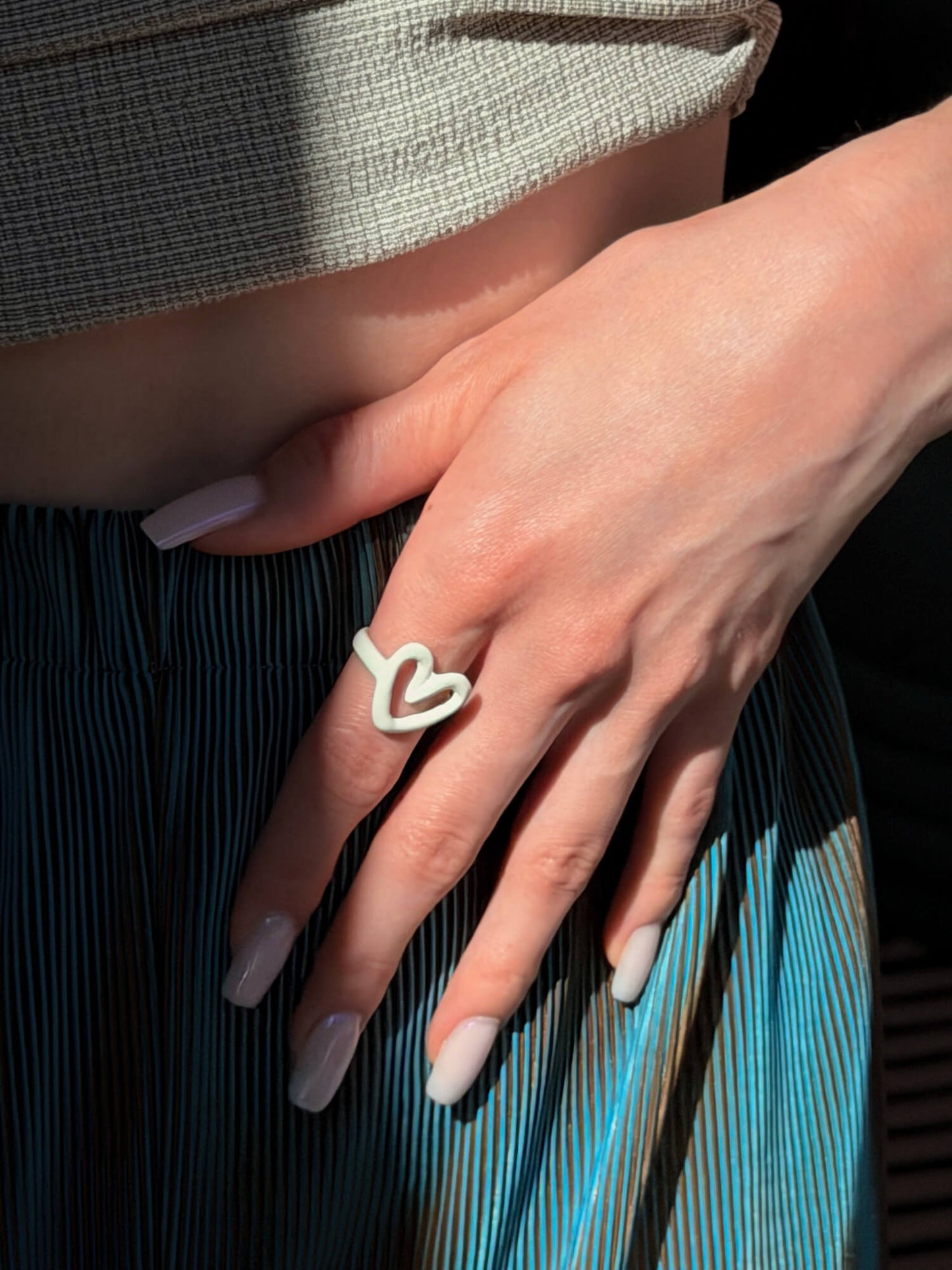 Ivory resin ring with open heart detail on model