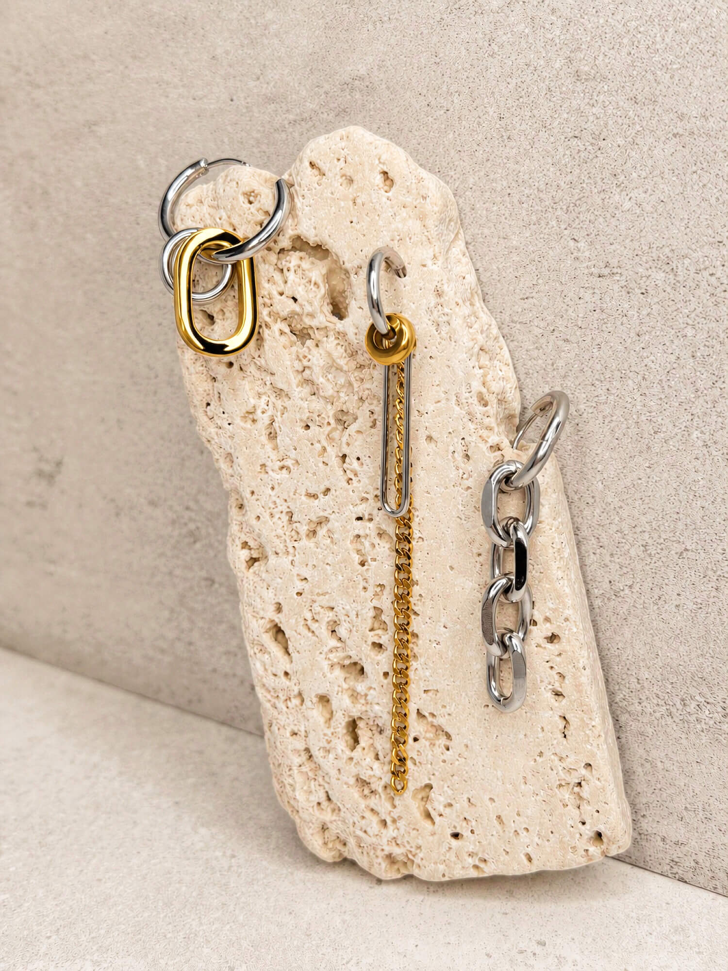 Dual link two-tone earring and chain drop earrings styled on stone