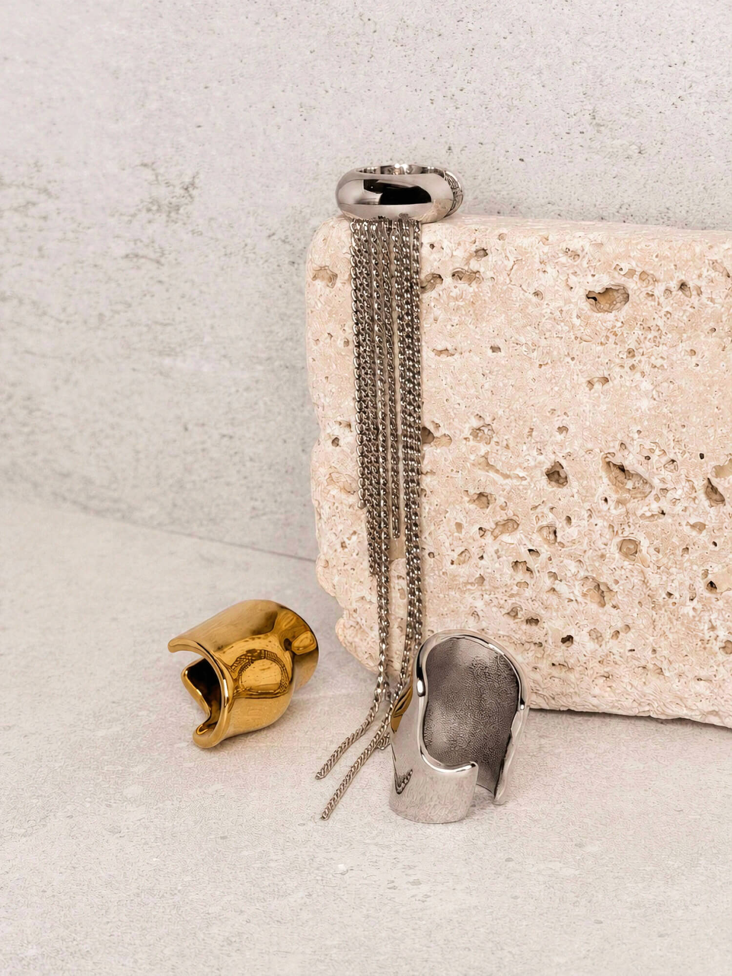 Silver chain fringe ear cuff styled with gold and silver molten ear cuffs on stone