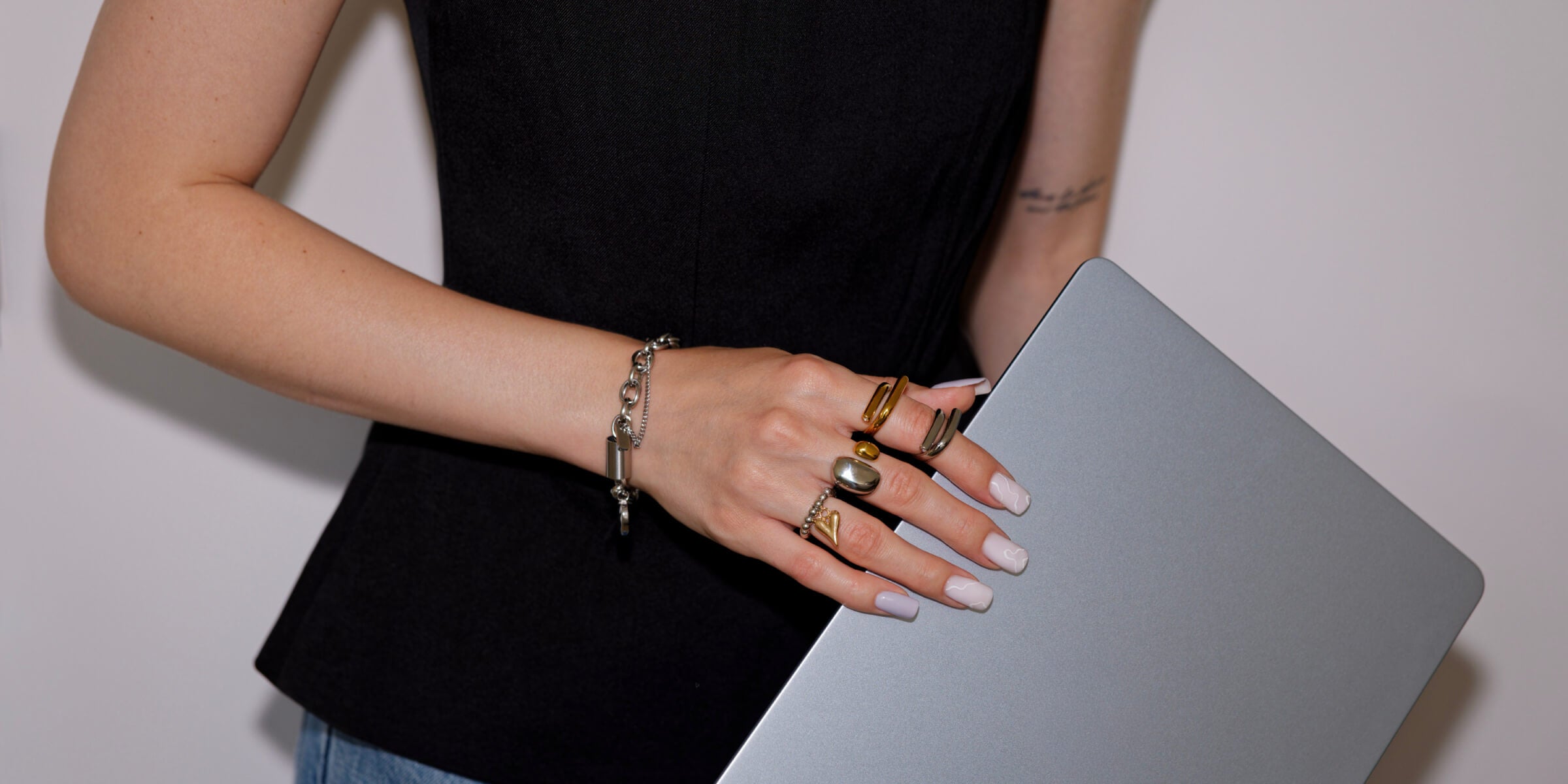 Model wearing modern gold and silver jewelry from the Alvijo collection.