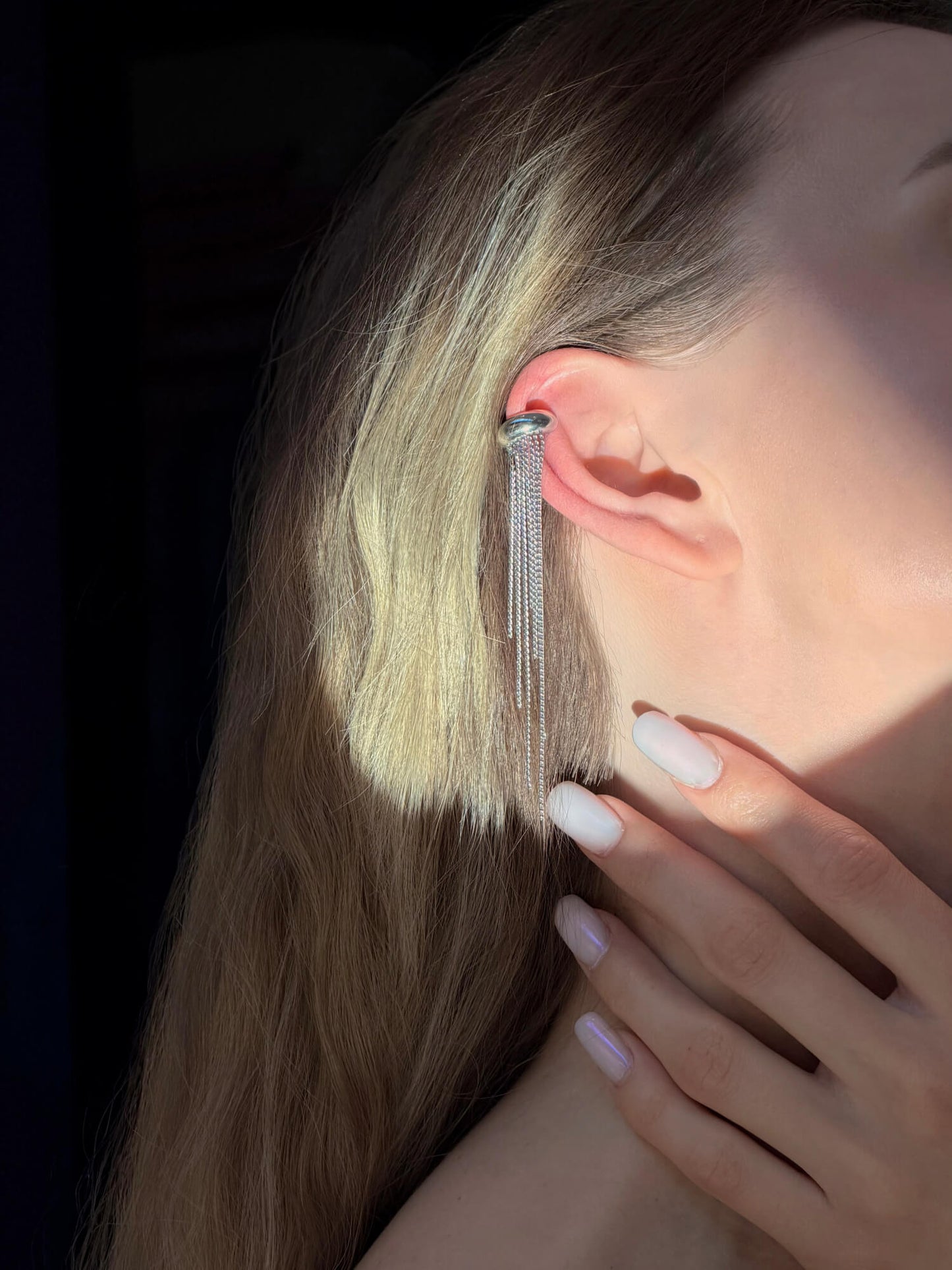 Model wearing cascade silver ear cuff on ear