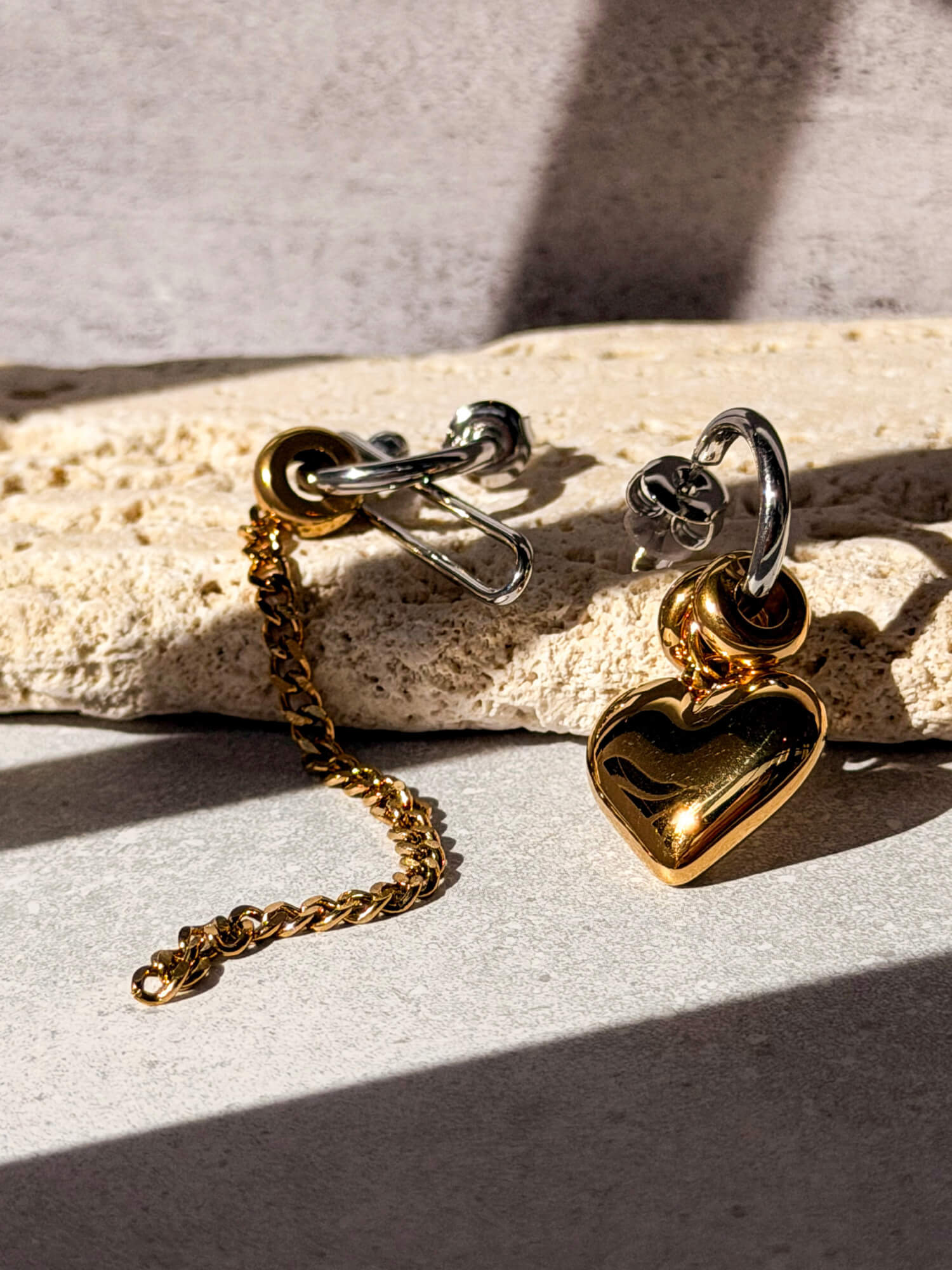 Gold heart charm earring detail with silver hoop