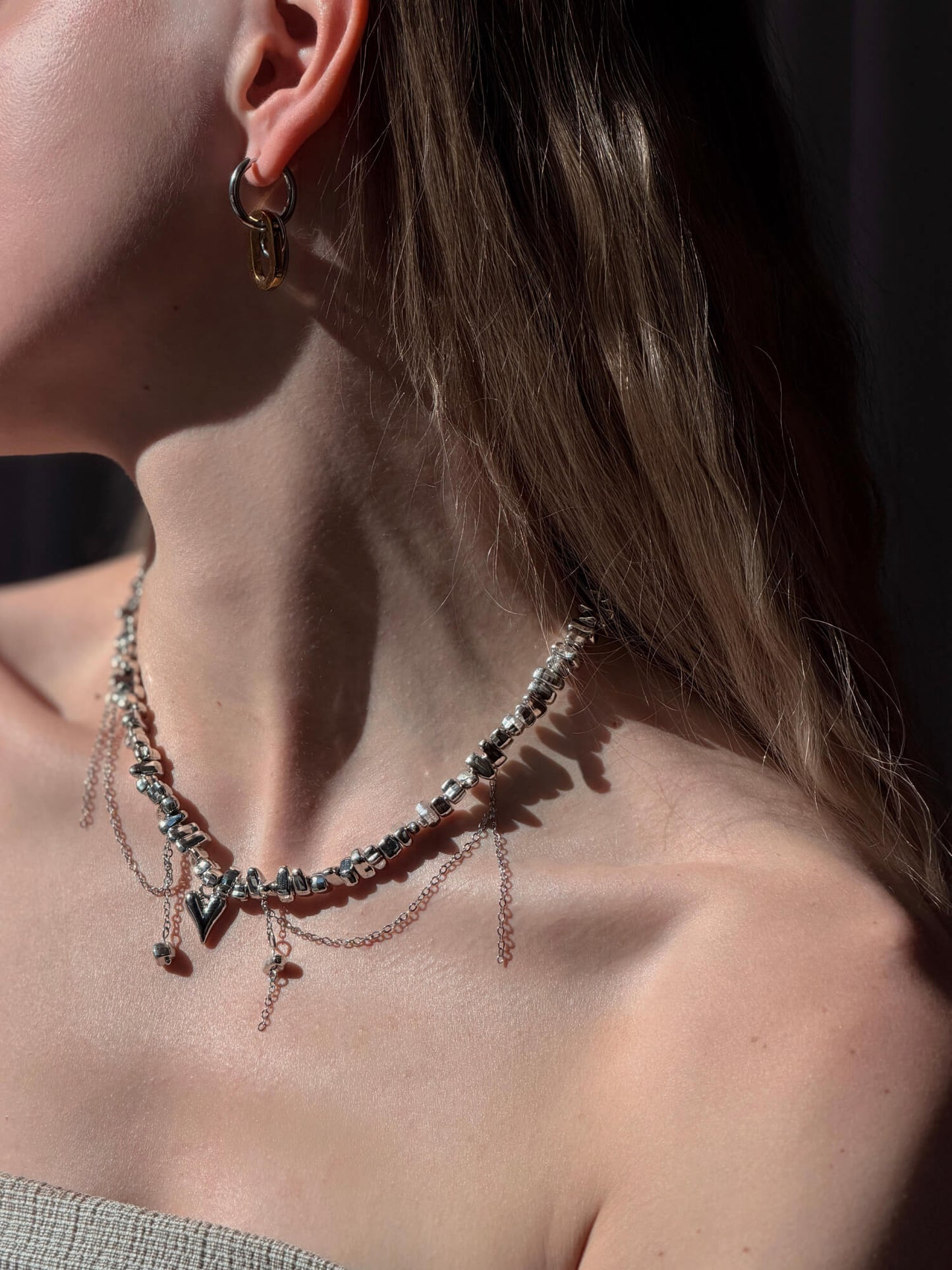 Model wearing drift silver beaded necklace