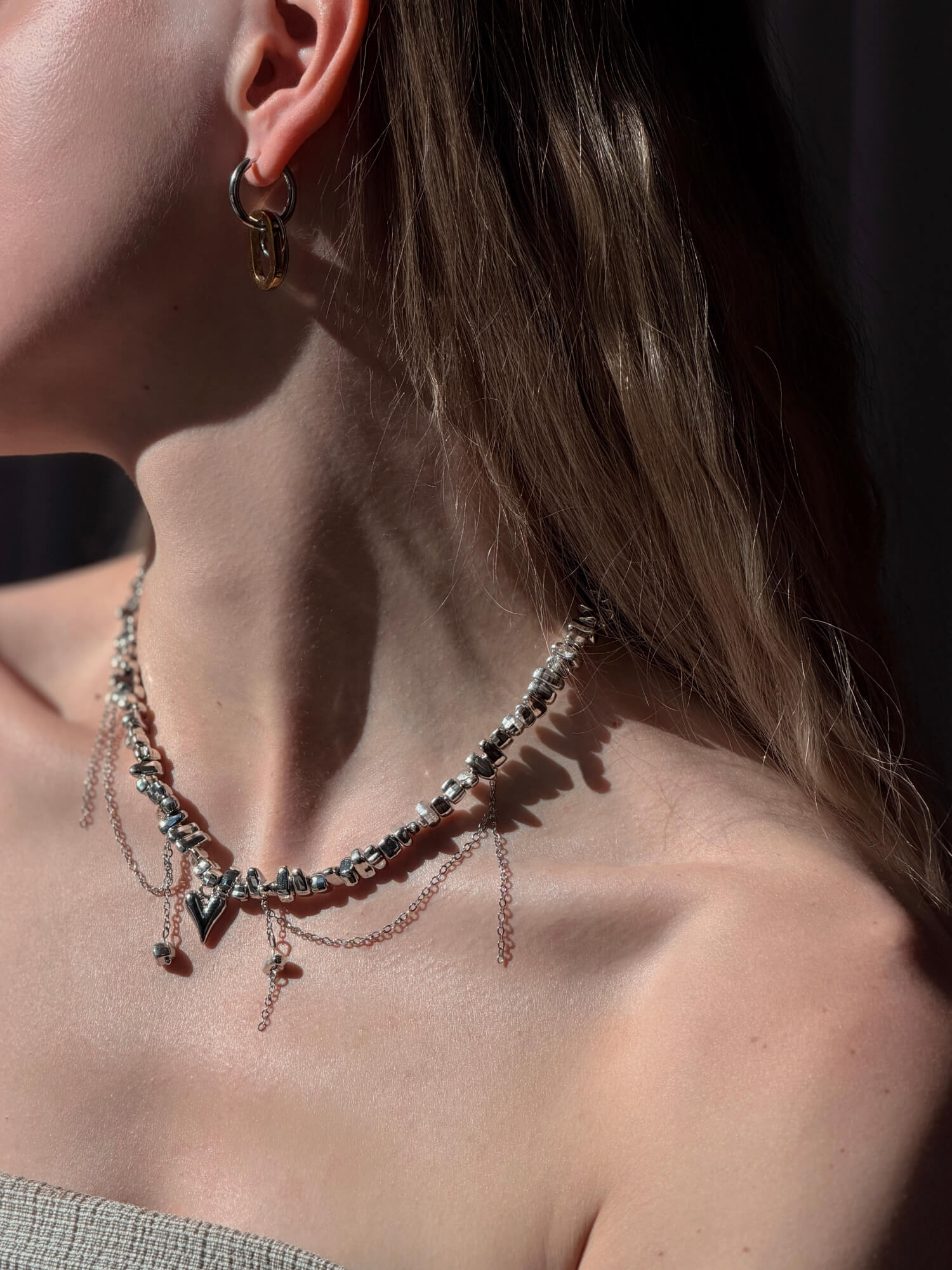 Model wearing drift silver beaded necklace