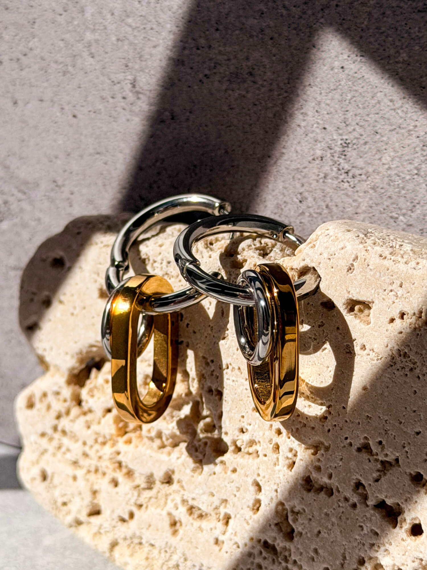 Gold oval link and silver circle detail on hoop earring