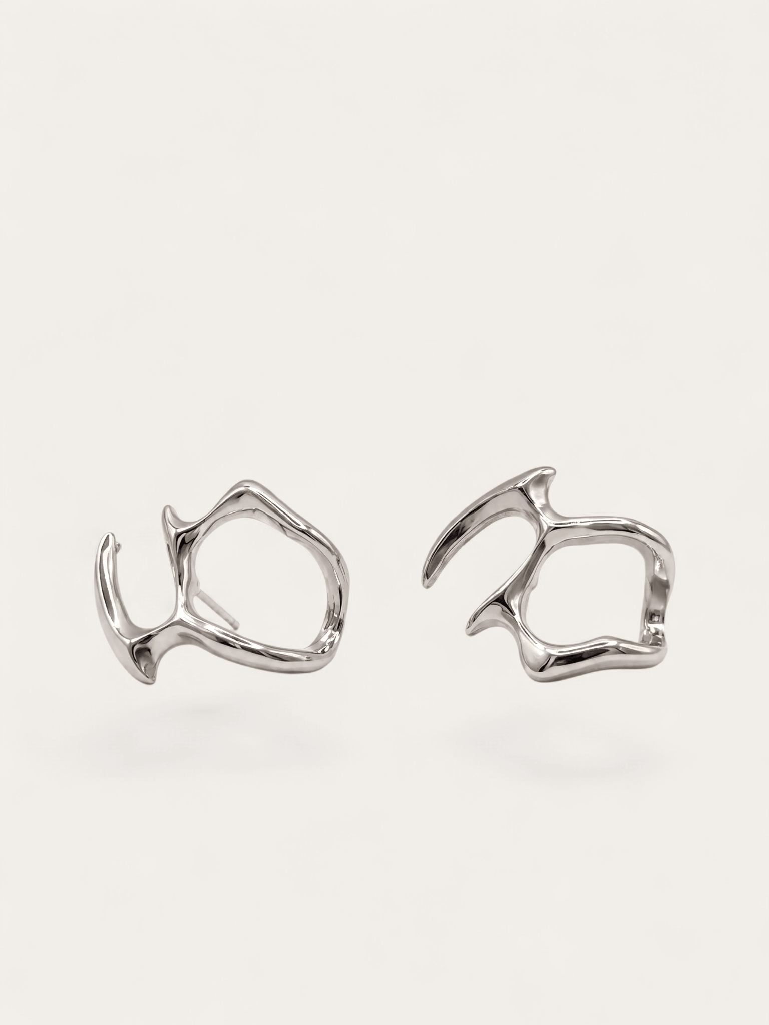 Fluid form silver earrings, abstract sculptural design