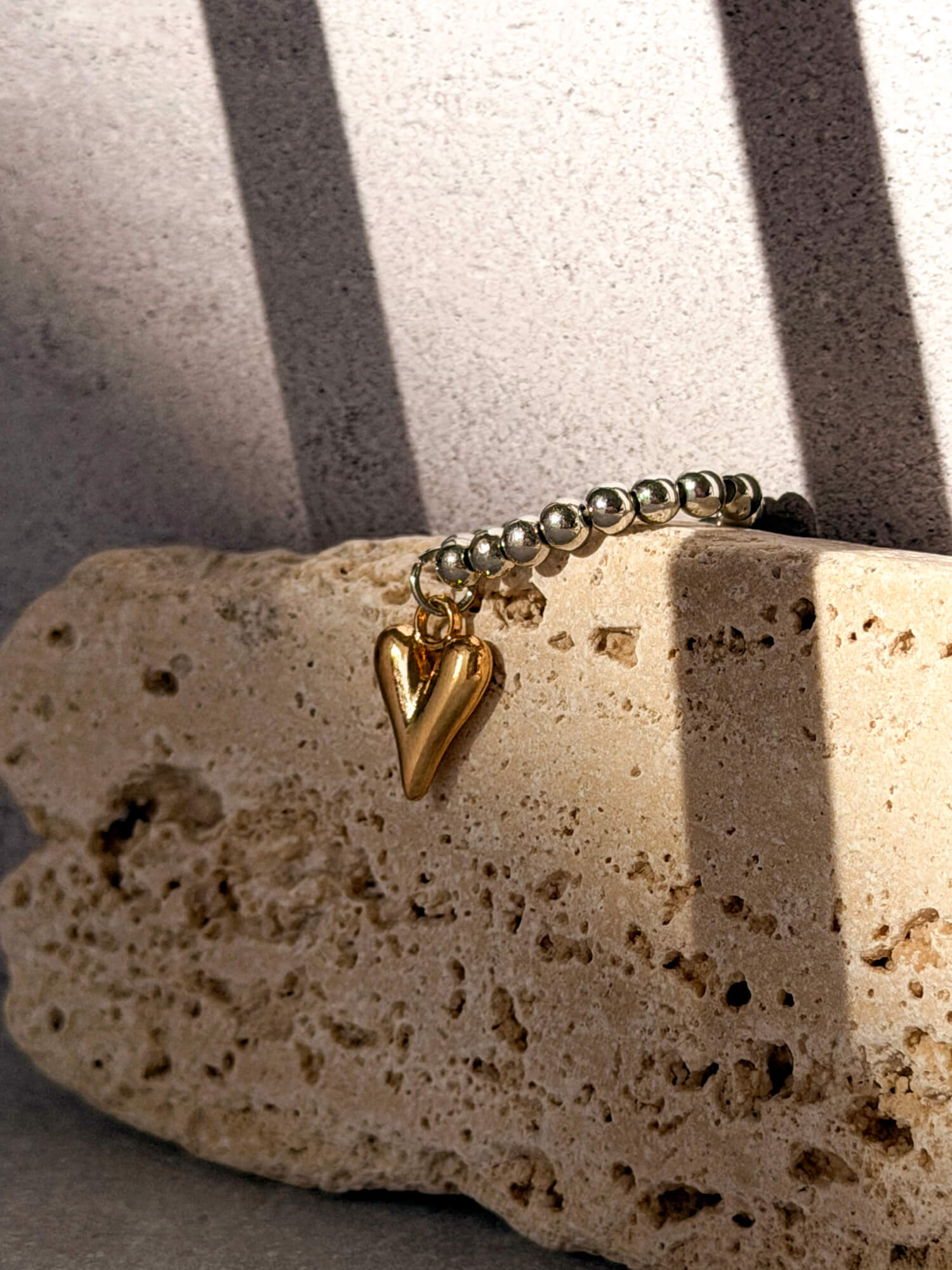 Gold heart charm detail on silver ball bead ring