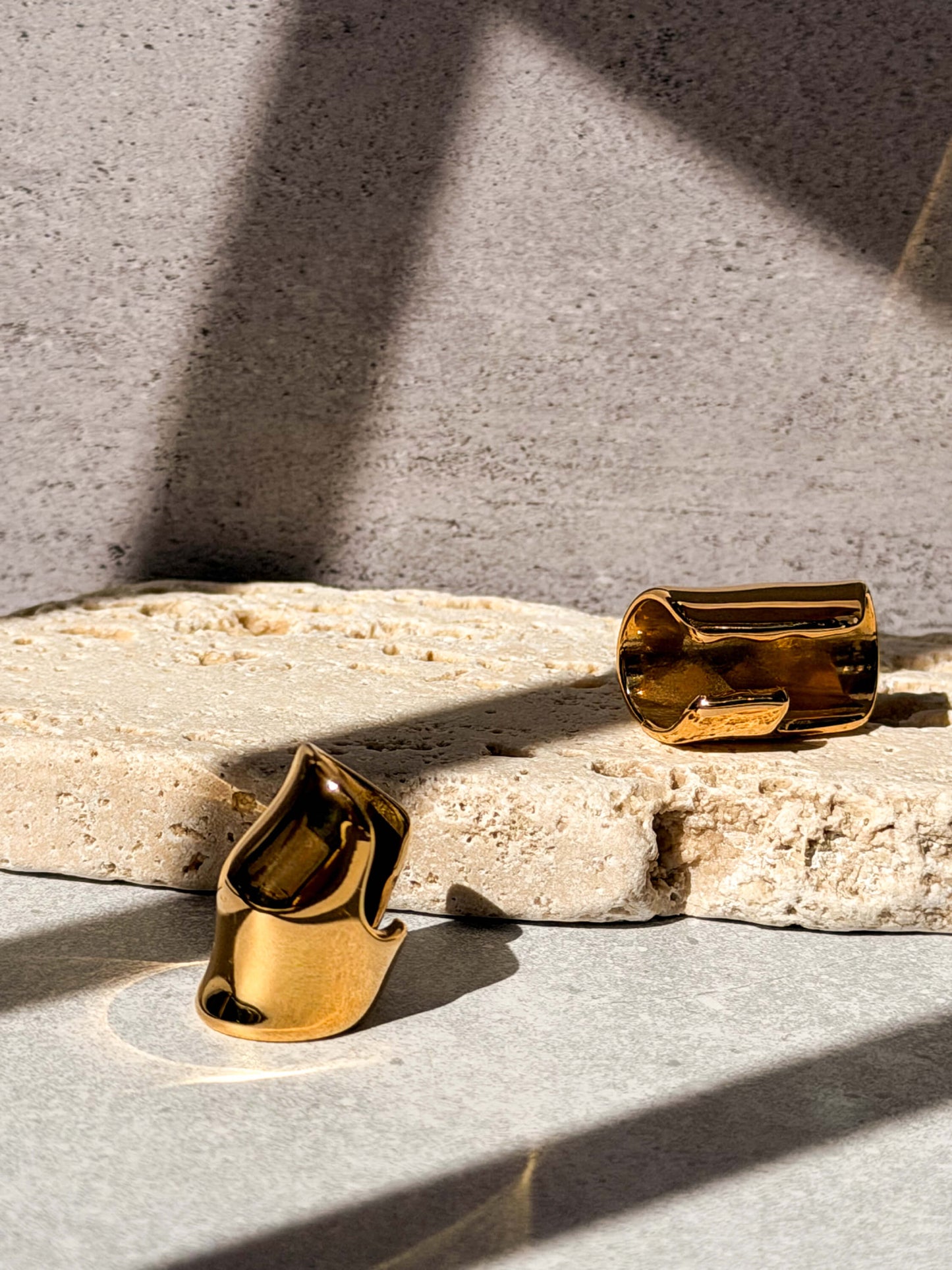 Gold ear cuff detail, sculptural fold texture