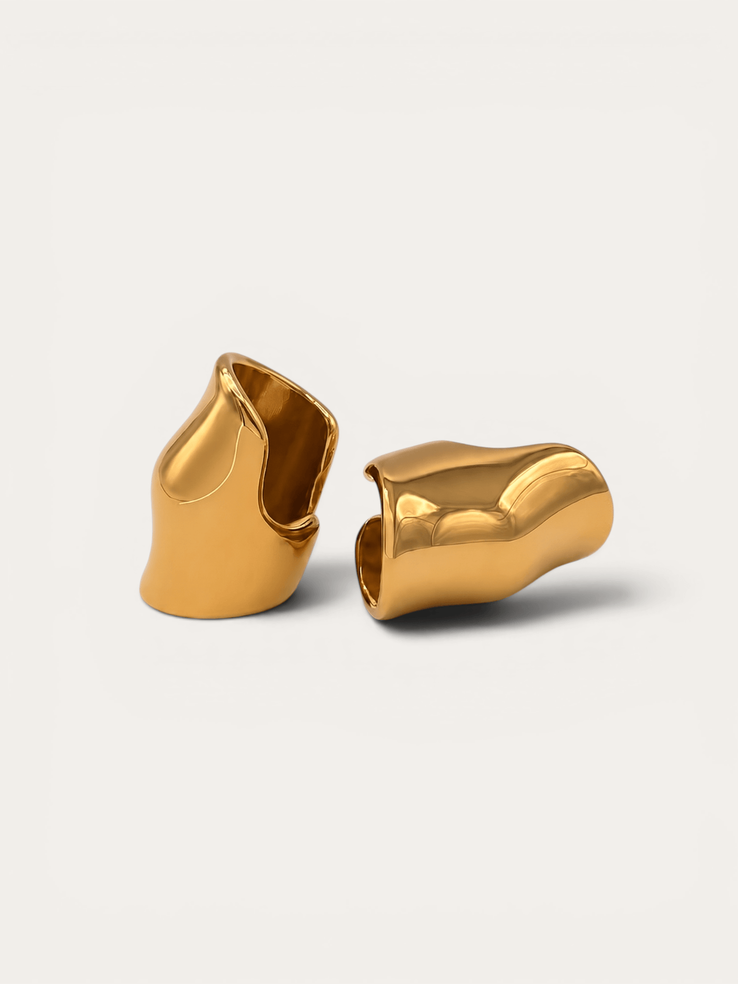 Molten gold ear cuffs, sculptural wave design