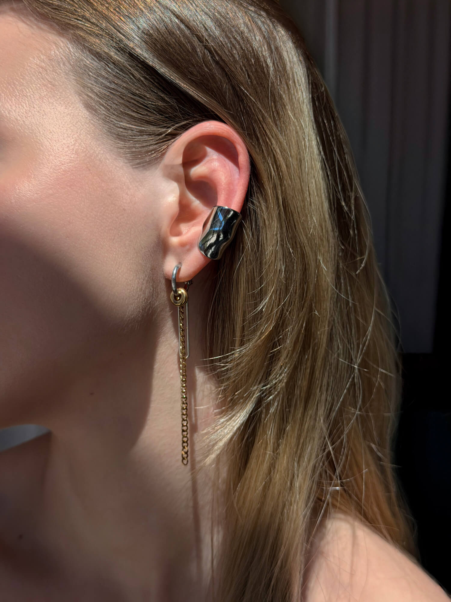 Model wearing molten silver ear cuffs