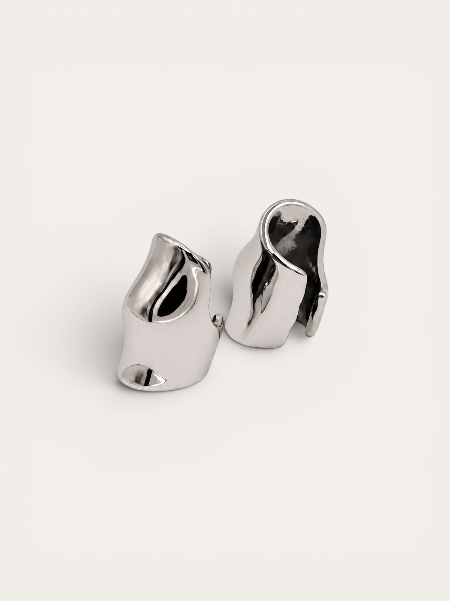 Molten silver ear cuffs, sculptural wave design