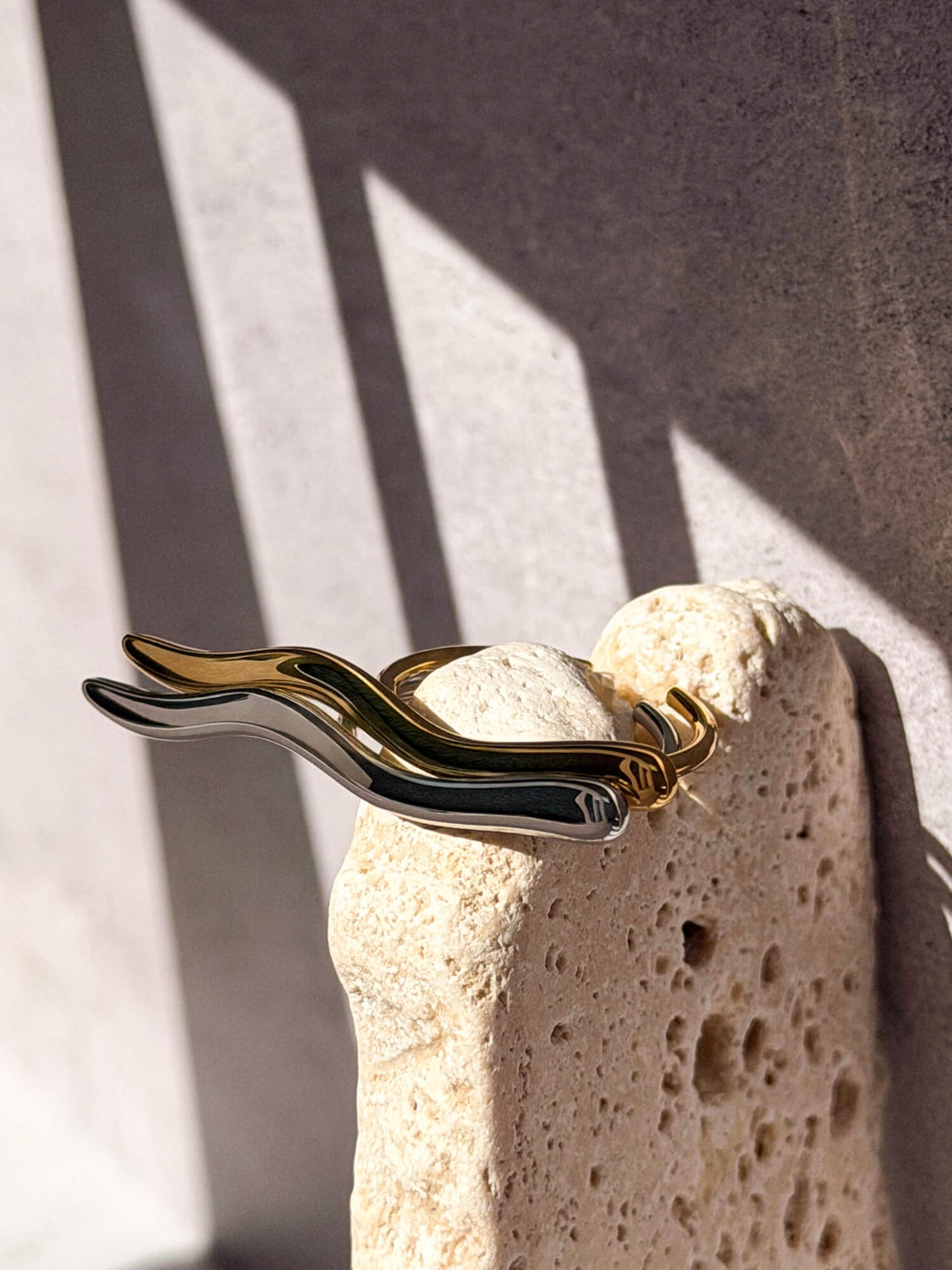 Gold and silver rings, curved wave finish